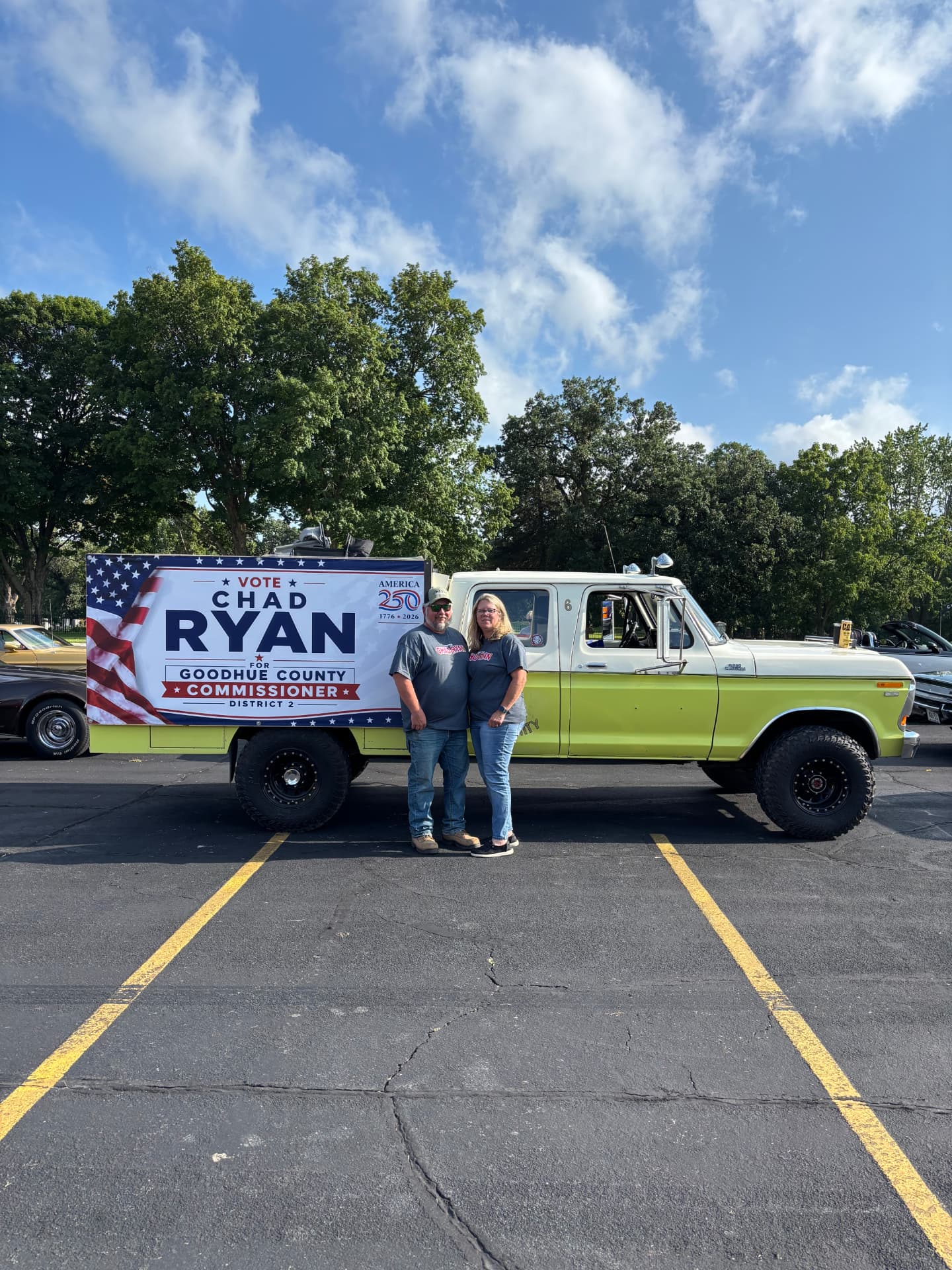 Chad Ryan and his wife beside a vintage Ford truck carrying a Vote Chad Ryan campaign sign at a car show in Goodhue County Minnesota.